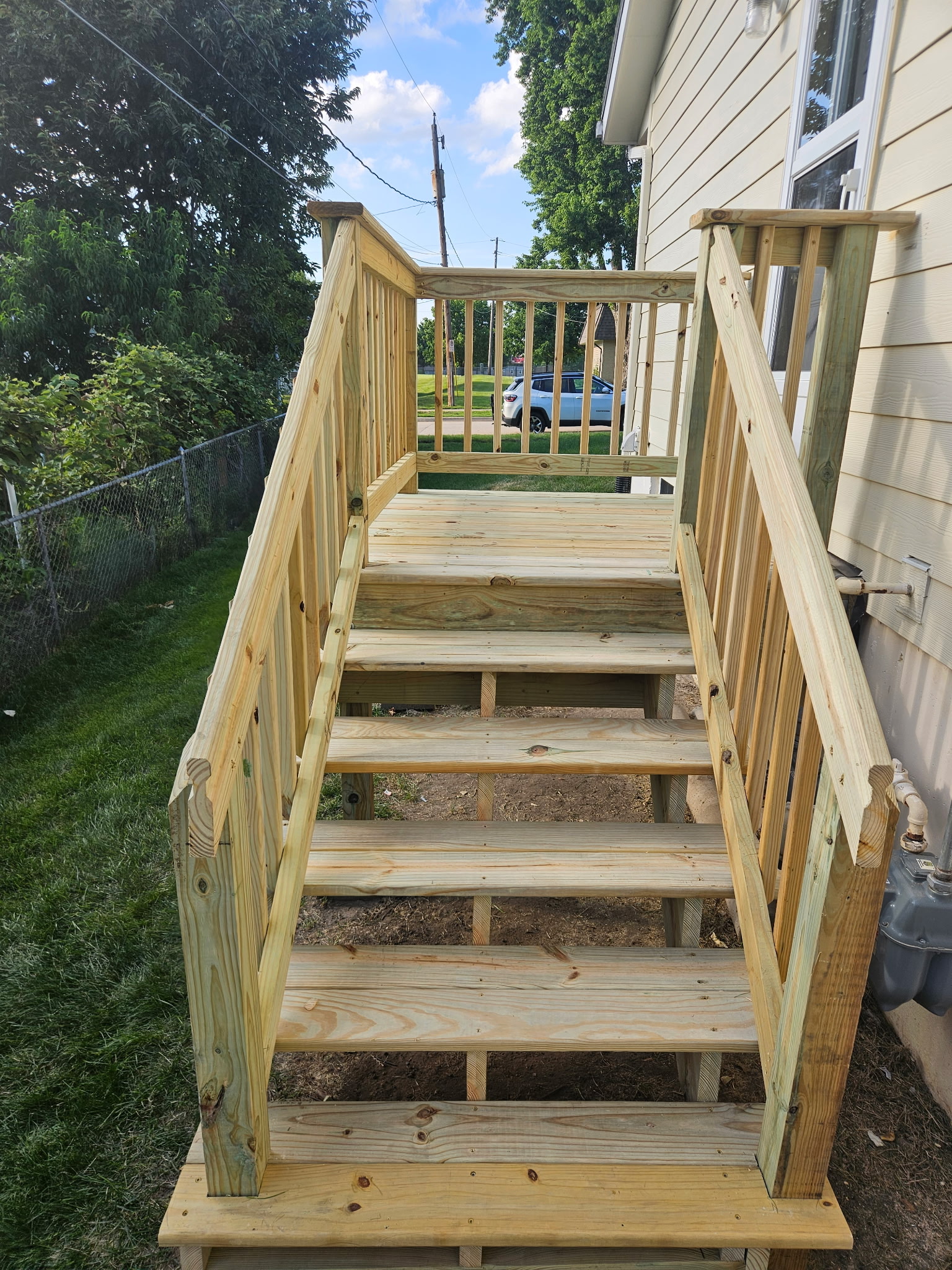 Updated wood deck stairs with new railings