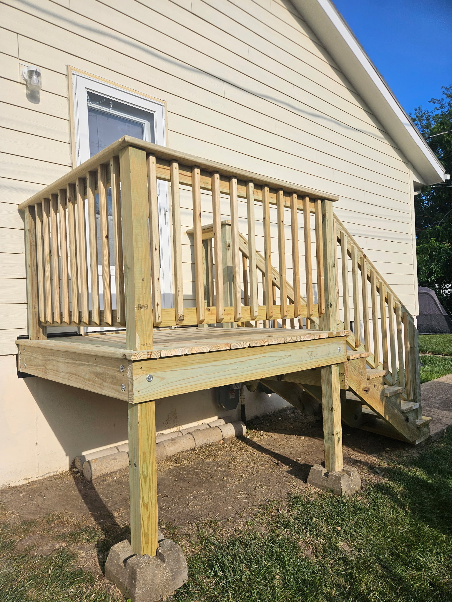 Updated wood deck with new railings and stairs
